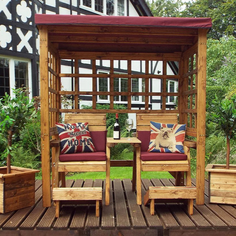 HENLEY TWIN SEAT ARBOUR BURG - face on, bulldog cushion, white and black house, garden, bushes, tress. 