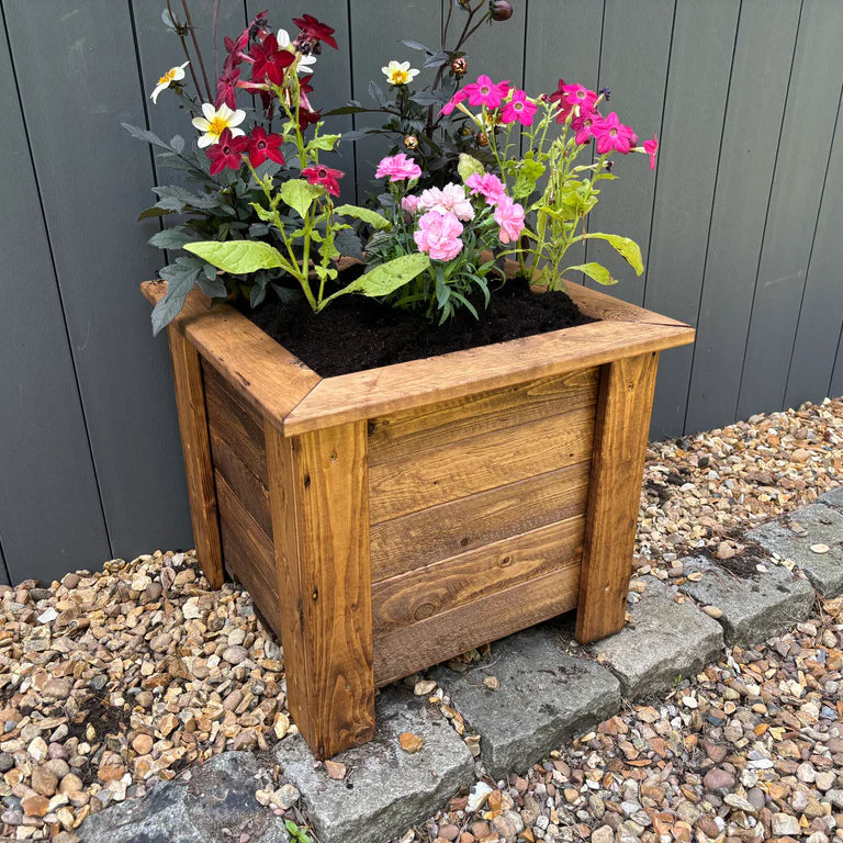 PRESTBURY RAISED SQUARE PLANTER LARGE - side on view, planted, soil, planter. wood. 