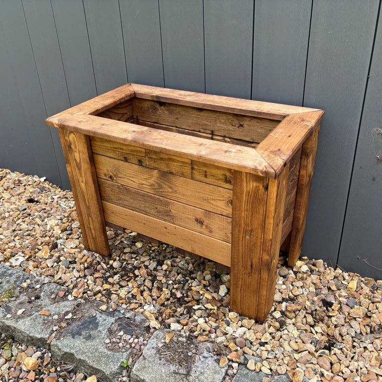 PRESTBURY RAISED RECTANGULAR TROUGH REGULAR - empty against garden fence and on gravel. 