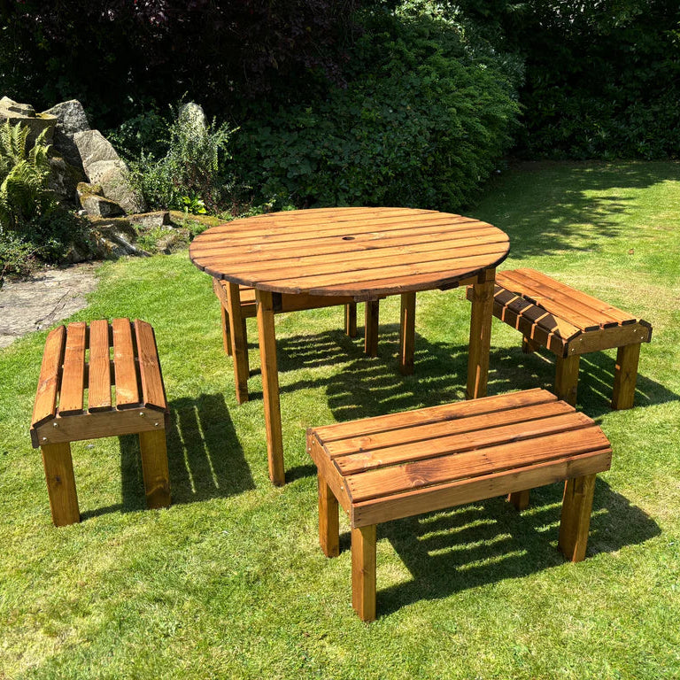 KNIGHTS FOUR SEATER ROUND TABLE SET - in the sunshine from the side, benches, tables, pond. 