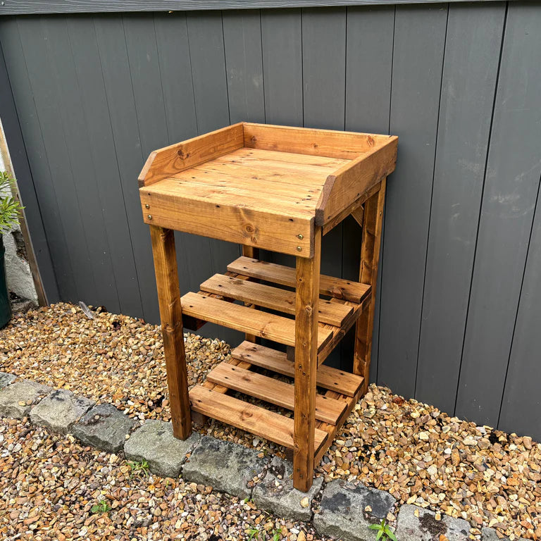 DELUXE DAVENPORT UTILITY/BBQ TABLE REGULAR- empty table against the grey fence, three shelves. 