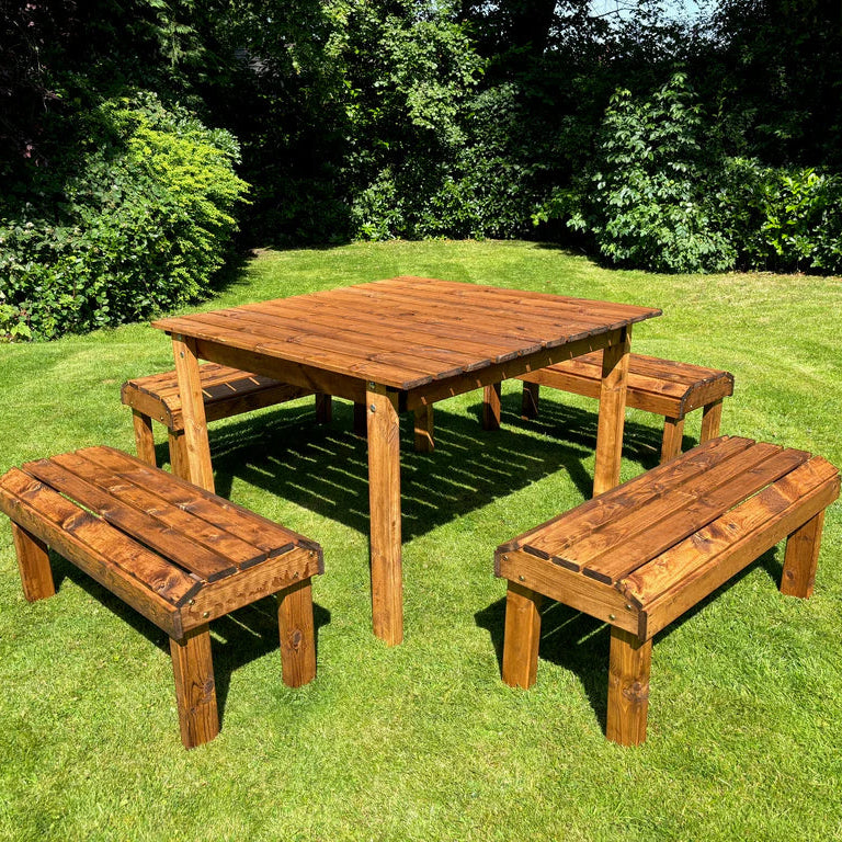 KNIGHTS 8 SEATER TABLE SET - four benches, table, garden, grass, hedges, bushes. 