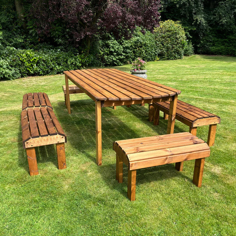 KNIGHTS TEN SEATER TABLE SET - empty, view from short edge, potted plant, sunshine. 