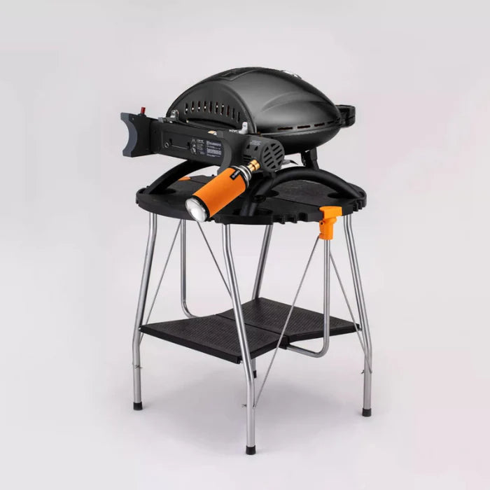A black o-grill 500 on a foldable stand against a white background