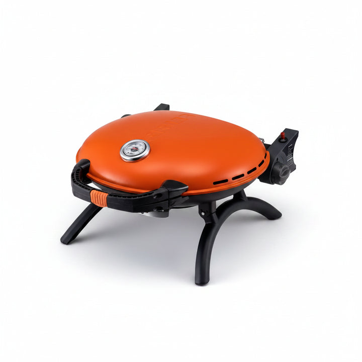 A closeup of the orange O-grill 600 against a grey background