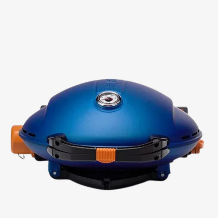 A closeup of a blue O-Grill 900 folded up and sat on its base