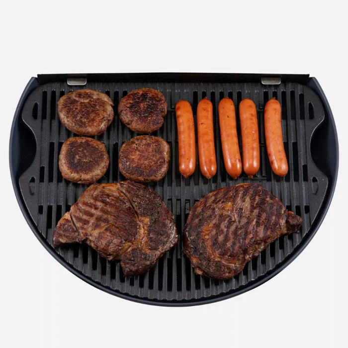 A closeup of the O-Grill 900 grill with steaks, burgers and sausages