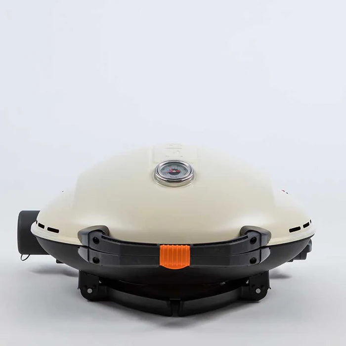A closeup of the O-Grill 900 in cream sitting on its base